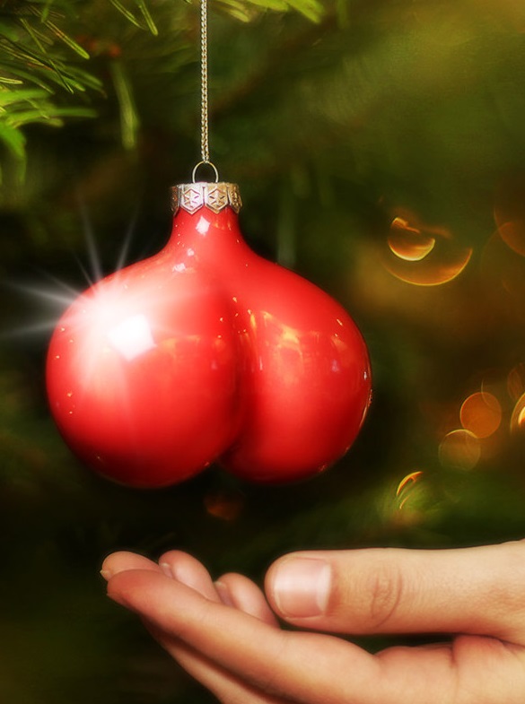 A ball sack shaped Christmas tree bourble, hanging just above Yvonne's palm